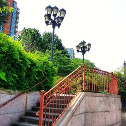 Street light by building against sky