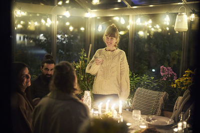 Friends having evening meal together