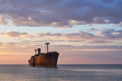 Shipwreck at sunrise with beautiful cloudy background