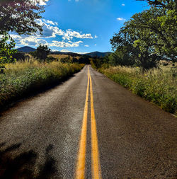 Surface level of empty road against sky