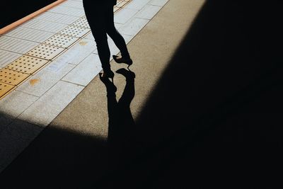 Low section of people standing on tiled floor