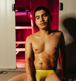 Portrait of shirtless man standing at home