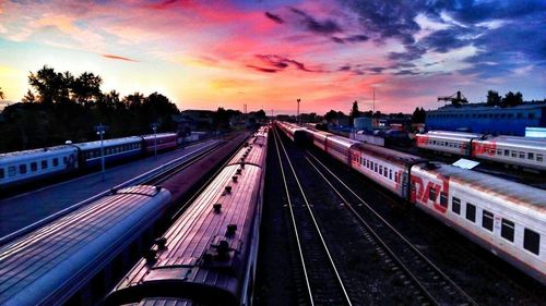 Railway tracks against sky at sunset