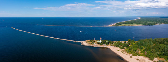 Aerial view of the lighthouse at the river bank and the sea.