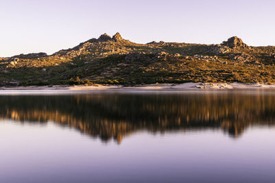 Scenic view of lake and mountains against clear sky