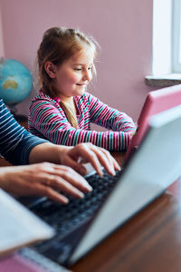 Little girl preschooler learning online solving puzzles playing educational games