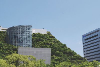 Low angle view of buildings against clear blue sky