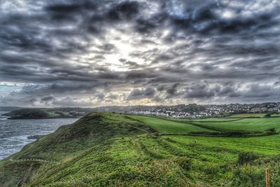 Scenic view of landscape against cloudy sky