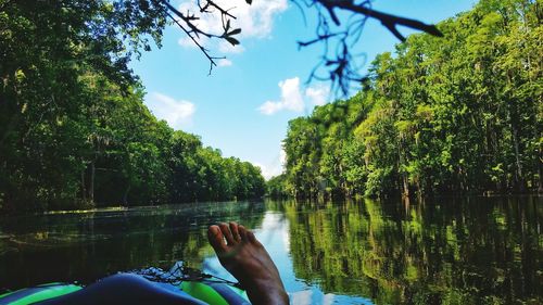 Feet of person on raft in river