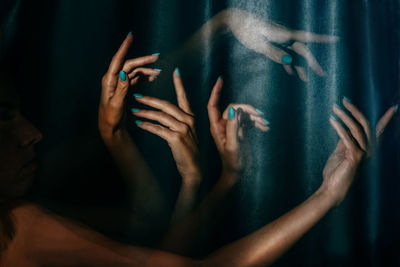 Multiple image of woman hands against curtain