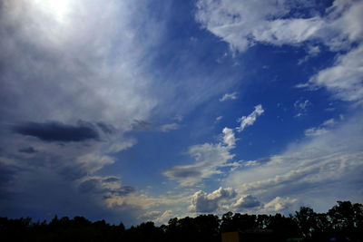 Low angle view of silhouette trees against sky