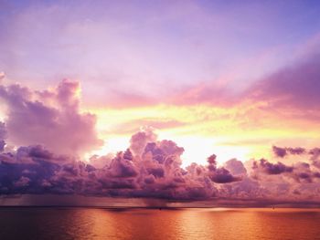 Scenic view of sea against dramatic sky during sunset