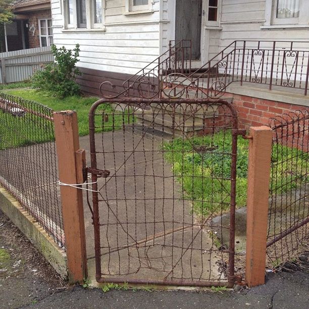 building exterior, built structure, architecture, fence, safety, protection, security, metal, railing, gate, chainlink fence, house, closed, metallic, day, outdoors, no people, door, residential structure, rusty