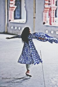 Young woman standing by railing