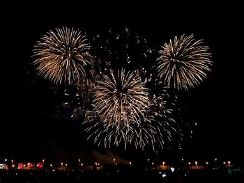 Low angle view of firework display at night