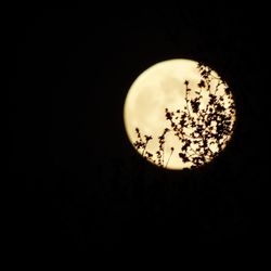 Low angle view of illuminated moon against sky at night