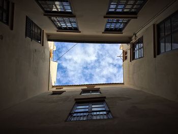 Low angle view of skylight amidst buildings