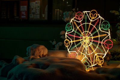 Illuminated ferris wheel at night