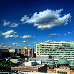 Buildings against cloudy sky