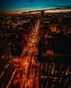 Aerial view of illuminated city against sky at night