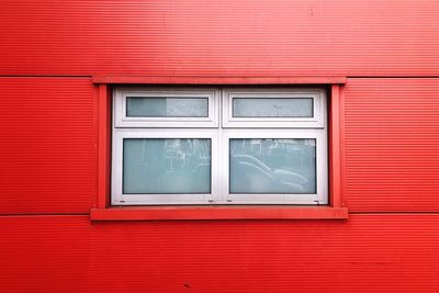 Close-up of window on red wall