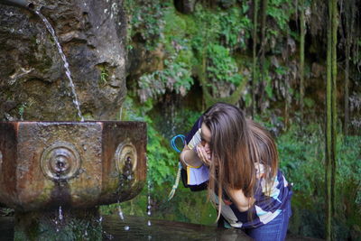 Side view of a woman drinking water