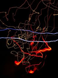 Close-up of light painting against black background