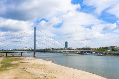 Bridge over river with city in background