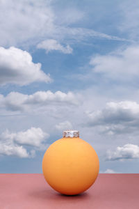 Close-up of orange against sky