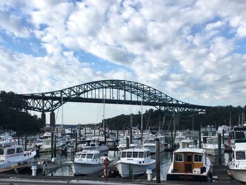 View of harbor against cloudy sky