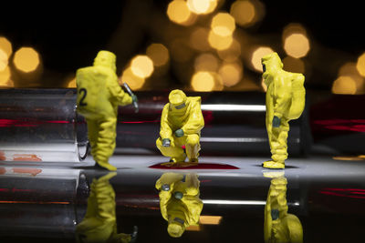 Close-up of yellow figurine on glass