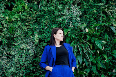 Woman standing against plants