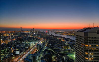 High angle view of illuminated buildings against sky at night