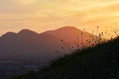 Scenic view of silhouette mountains against sky during sunset