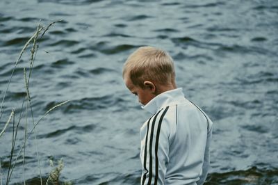 Rear view of man standing in sea