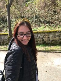Portrait of smiling woman standing outdoors