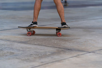 Low section of man skateboarding on skateboard