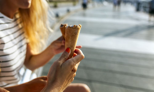 Midsection of woman holding ice cream