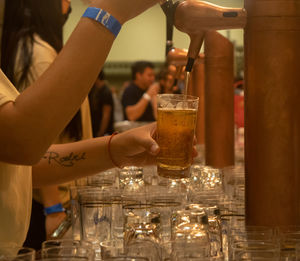 Cropped image of people toasting drinks on table