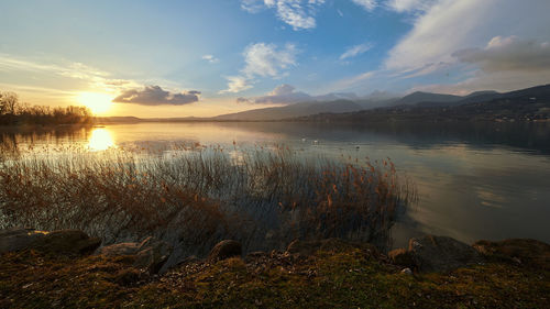 Scenic view of lake against sky during sunset