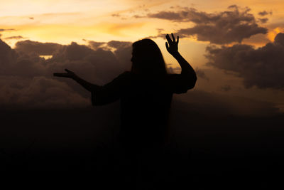 Silhouette man standing against sky during sunset