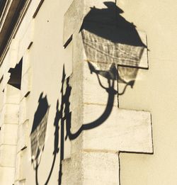 Low angle view of arrow sign on wall