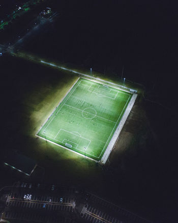 Aerial view of illuminated soccer field at night