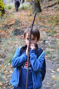 Portrait of cute girl in autumn leaves