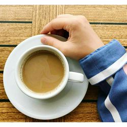 Midsection of coffee cup on table