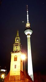 Low angle view of illuminated tower at night