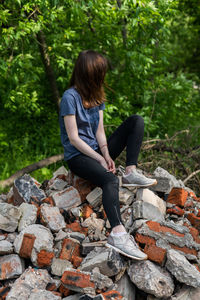 Woman sitting on rock