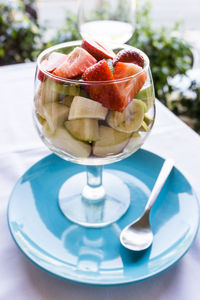 Close-up of fruit salad served in wineglass on table
