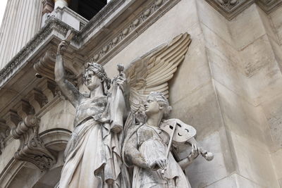 Low angle view of statue against historic building