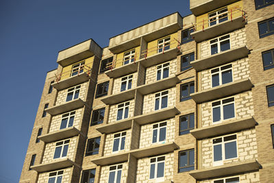 Facade of building. unfinished house. windows in new multi-storey building. 